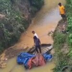 Truck Accident: Speeding truck plunges 70 feet into a raging drain; driver's body recovered after cutting open the cabin.